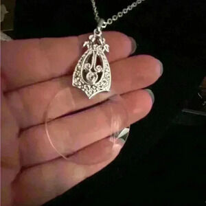 Vintage silver tone magnifying glass necklace